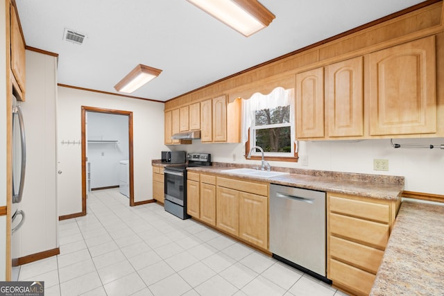 kitchen with light brown cabinetry, sink, and appliances with stainless steel finishes