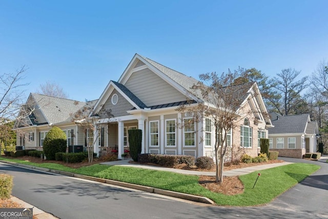 craftsman inspired home with a front lawn