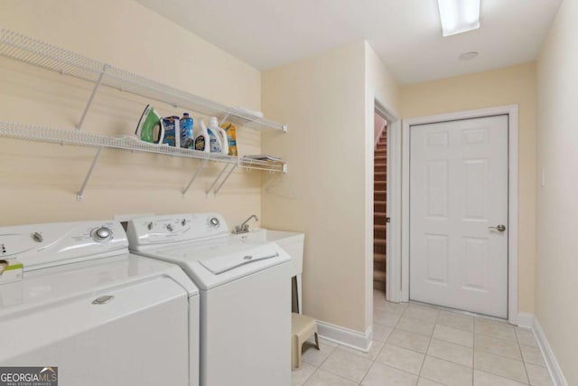 washroom with light tile patterned floors and washer and dryer