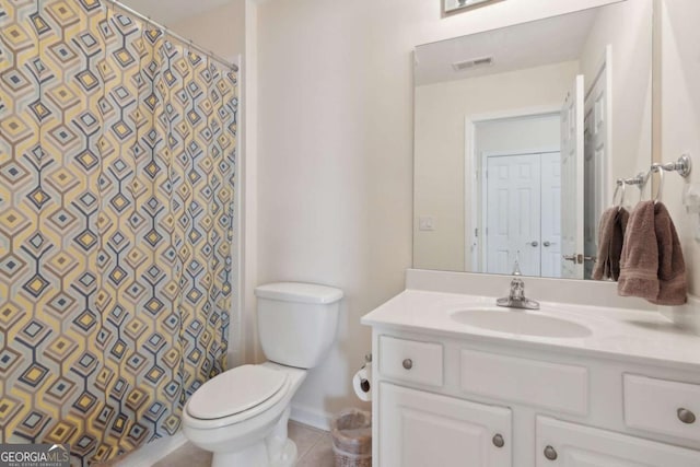 bathroom featuring tile patterned flooring, vanity, curtained shower, and toilet