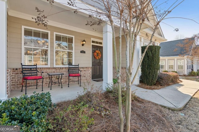 view of exterior entry with covered porch