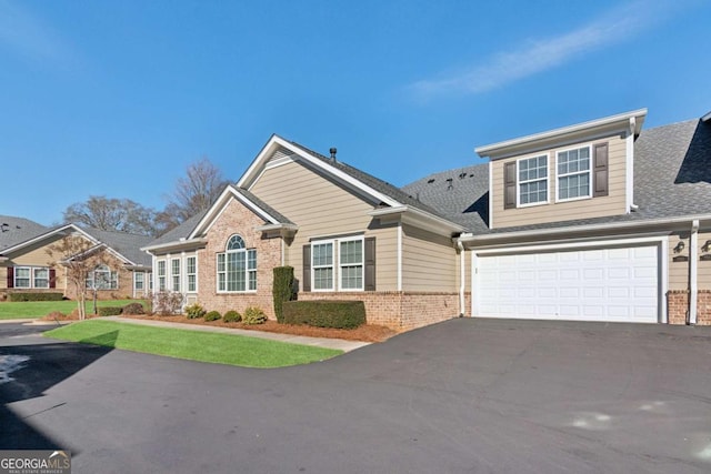 view of front of home featuring a front yard and a garage