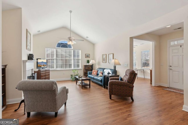 living room featuring hardwood / wood-style floors, ceiling fan, and lofted ceiling