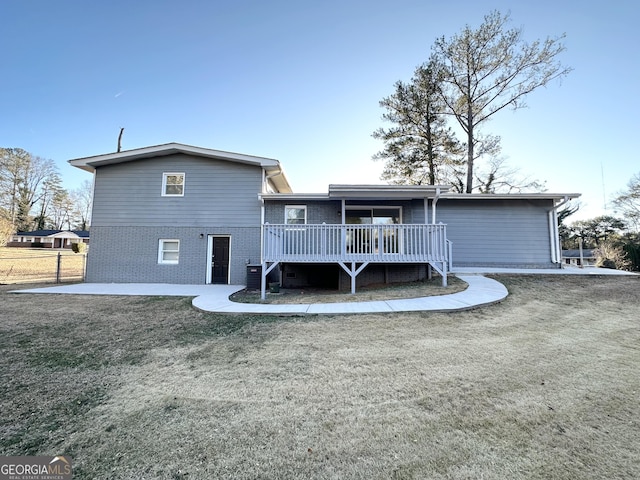 back of property featuring a lawn, a wooden deck, a patio area, and central air condition unit