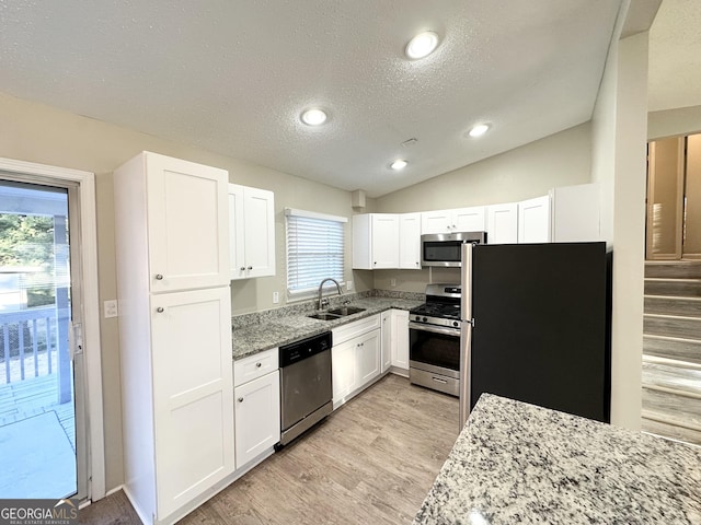 kitchen featuring white cabinets, light stone counters, sink, and stainless steel appliances