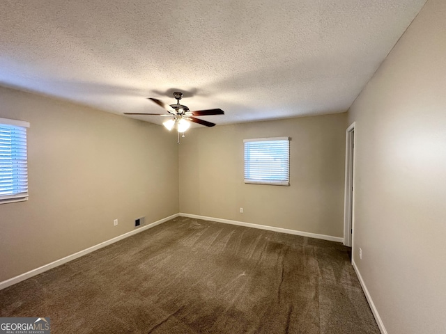 carpeted spare room featuring a textured ceiling and ceiling fan