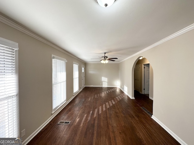 empty room featuring ceiling fan, dark hardwood / wood-style floors, and ornamental molding