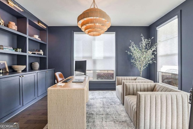 office featuring built in shelves and dark hardwood / wood-style flooring