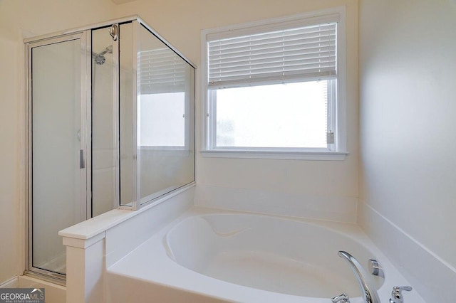 bathroom featuring separate shower and tub