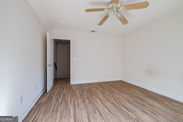 spare room featuring ceiling fan and hardwood / wood-style flooring