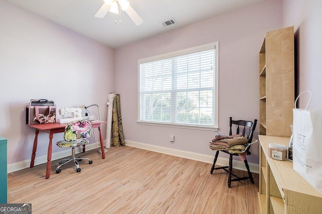 office with ceiling fan and light hardwood / wood-style flooring