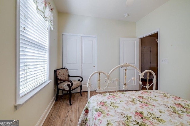 bedroom with light hardwood / wood-style flooring and a closet