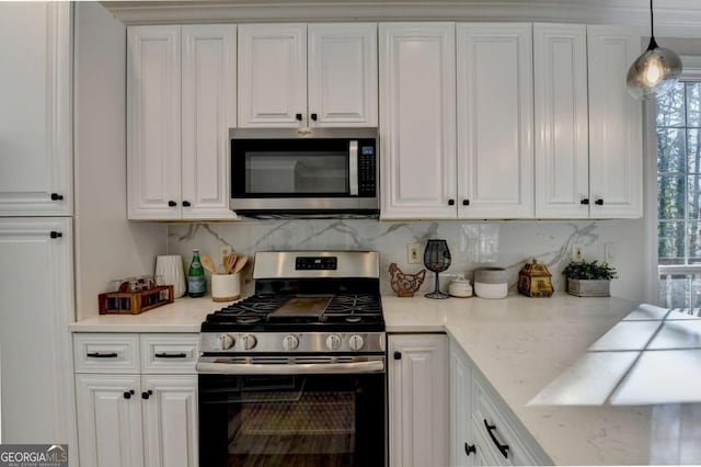 kitchen featuring appliances with stainless steel finishes and white cabinetry