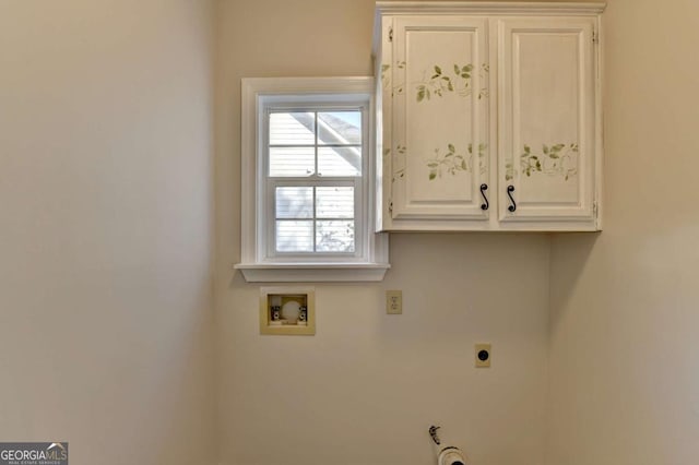 laundry area with electric dryer hookup, hookup for a washing machine, and cabinets