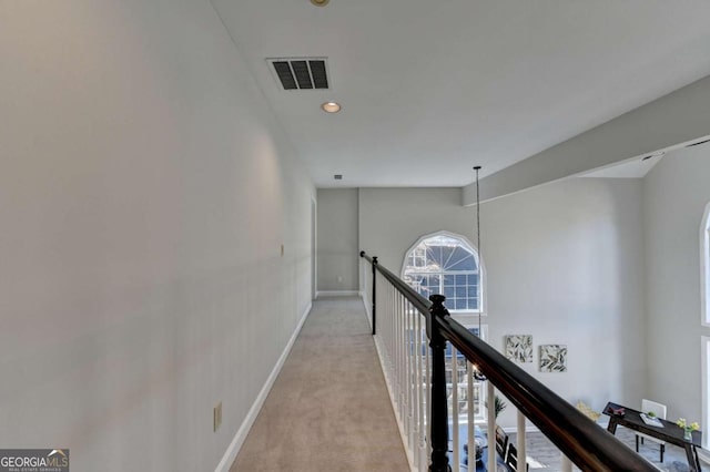 corridor with light colored carpet