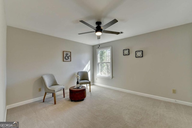 living area with ceiling fan and light colored carpet