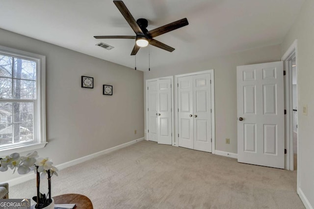 unfurnished bedroom with light carpet and ceiling fan