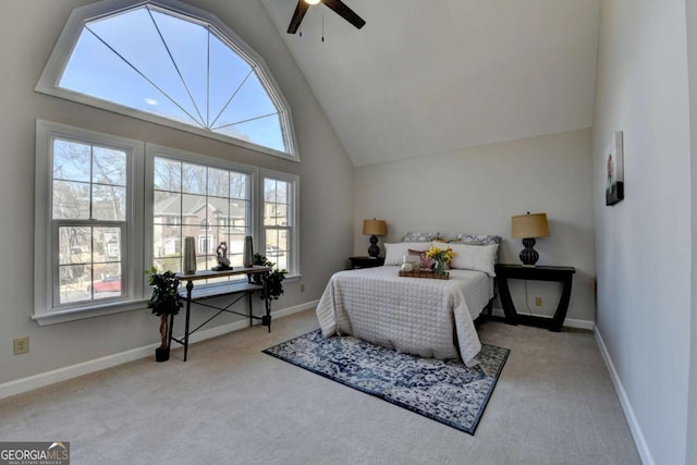 carpeted bedroom featuring high vaulted ceiling and ceiling fan