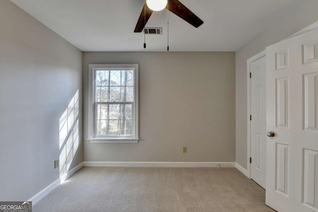 carpeted empty room featuring ceiling fan