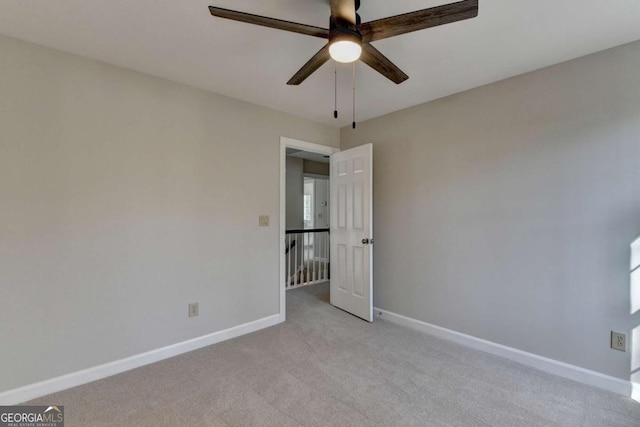 unfurnished room with ceiling fan and light colored carpet