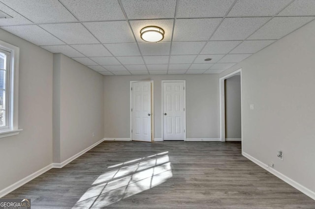 spare room with hardwood / wood-style flooring, a paneled ceiling, and a healthy amount of sunlight