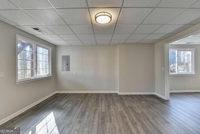 unfurnished room featuring electric panel and dark hardwood / wood-style floors