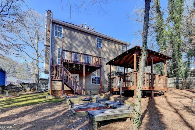 rear view of house with a wooden deck