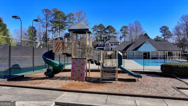 view of playground with a community pool