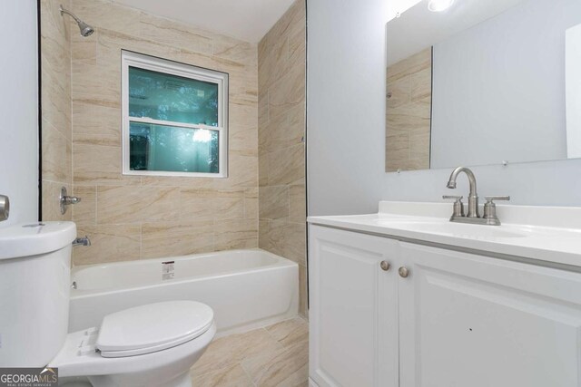 full bathroom featuring vanity, toilet, and tiled shower / bath combo