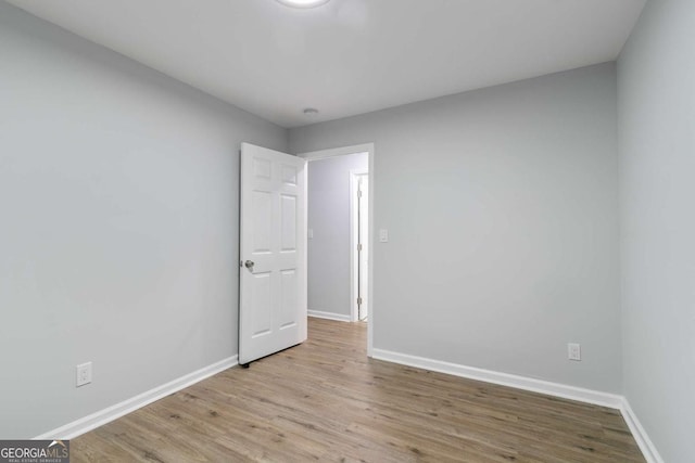 unfurnished room with light wood-type flooring