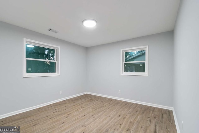 unfurnished room with light hardwood / wood-style floors