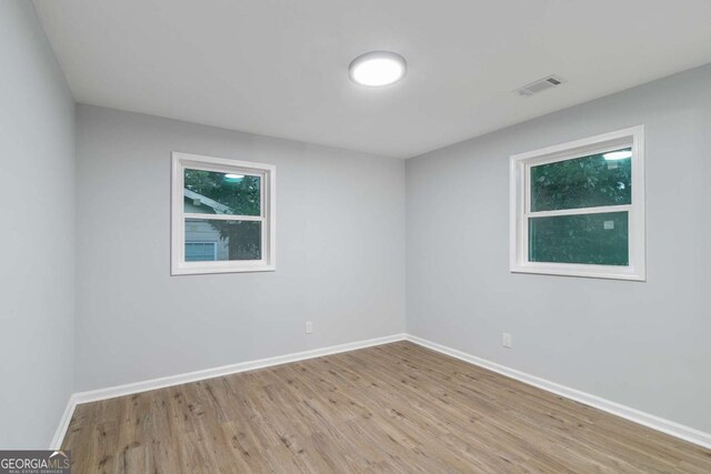 empty room with light hardwood / wood-style flooring