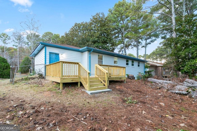 rear view of property featuring a deck