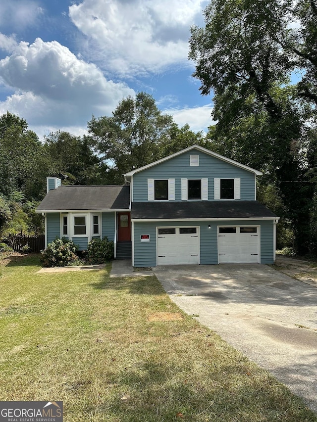 tri-level home with a front yard and a garage