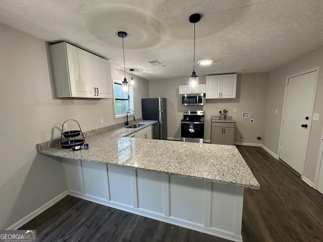 kitchen featuring kitchen peninsula, white cabinetry, sink, and appliances with stainless steel finishes