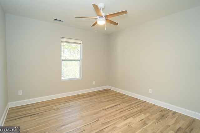 spare room featuring light wood-type flooring and ceiling fan