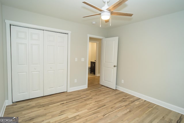 unfurnished bedroom featuring ceiling fan, a closet, and light hardwood / wood-style flooring