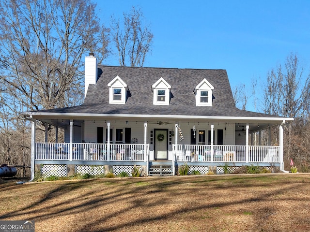 farmhouse with covered porch and a front lawn