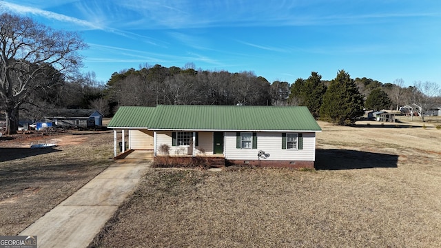 ranch-style house with a front lawn and covered porch