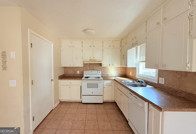 kitchen with decorative backsplash, white appliances, sink, light tile patterned floors, and white cabinets