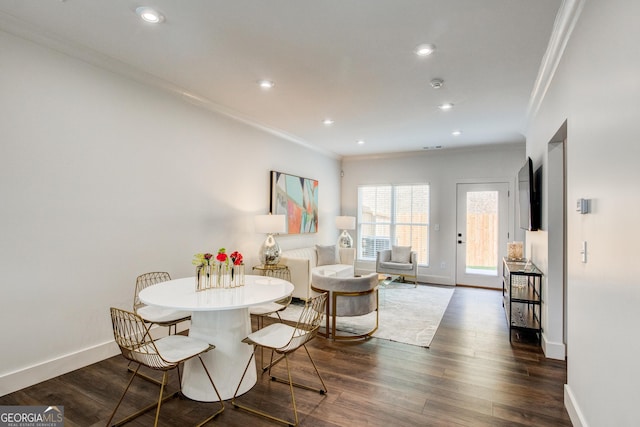 dining space featuring ornamental molding and dark hardwood / wood-style flooring