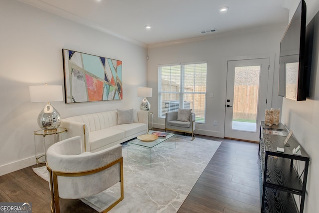 living room featuring dark wood-type flooring and ornamental molding