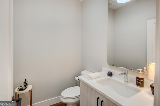 bathroom with toilet and vanity