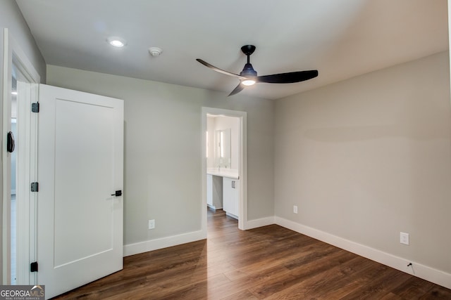 unfurnished bedroom featuring ceiling fan, dark hardwood / wood-style flooring, and ensuite bath