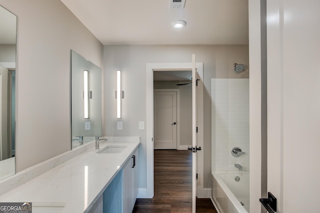 bathroom featuring tub / shower combination, vanity, and hardwood / wood-style flooring