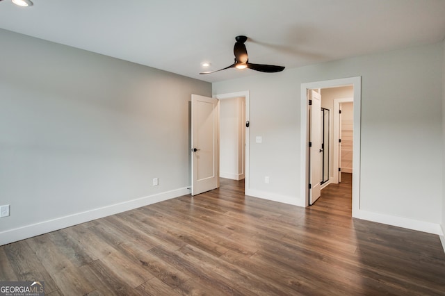 unfurnished bedroom featuring ceiling fan and dark hardwood / wood-style flooring