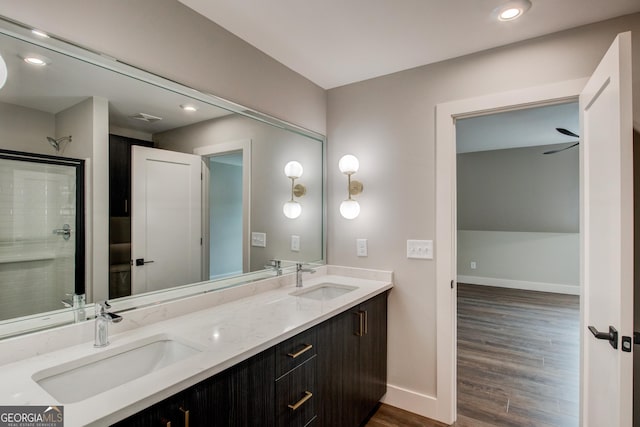 bathroom with a shower with door, vanity, and hardwood / wood-style floors