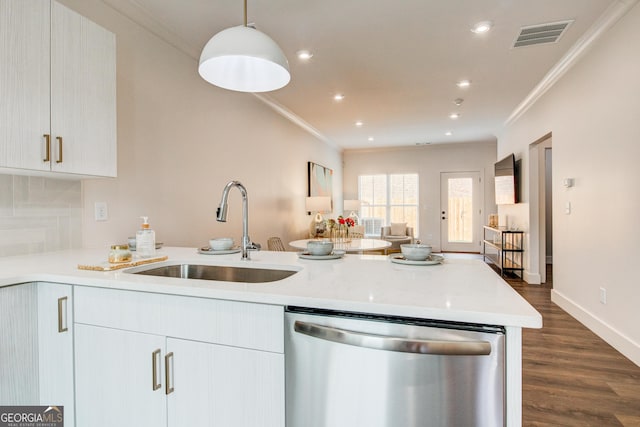 kitchen featuring ornamental molding, pendant lighting, dark hardwood / wood-style floors, sink, and stainless steel dishwasher