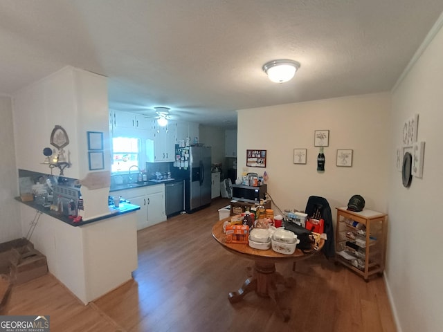 dining area with hardwood / wood-style floors and ceiling fan