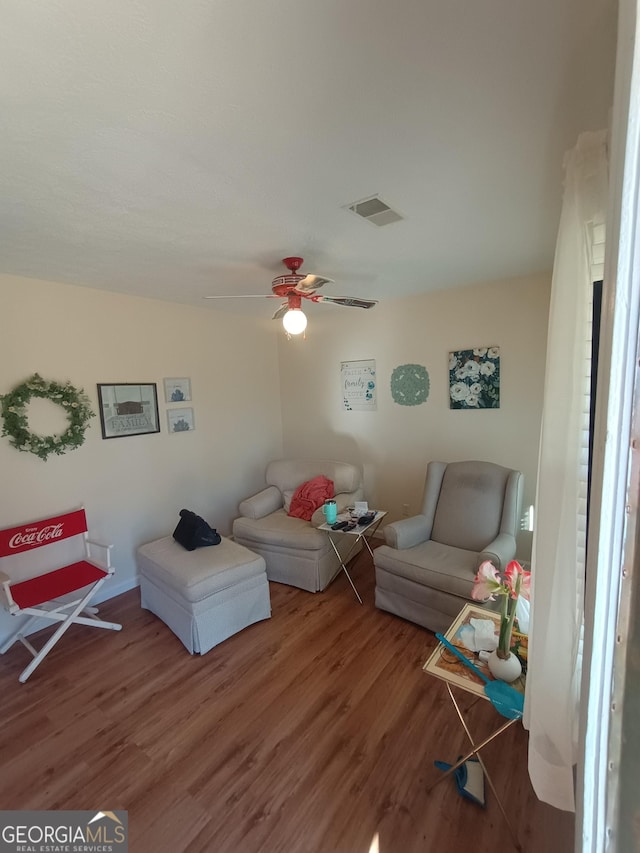 living room featuring hardwood / wood-style flooring and ceiling fan